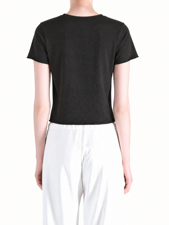 Black tee worn by a person, showing the tee fit