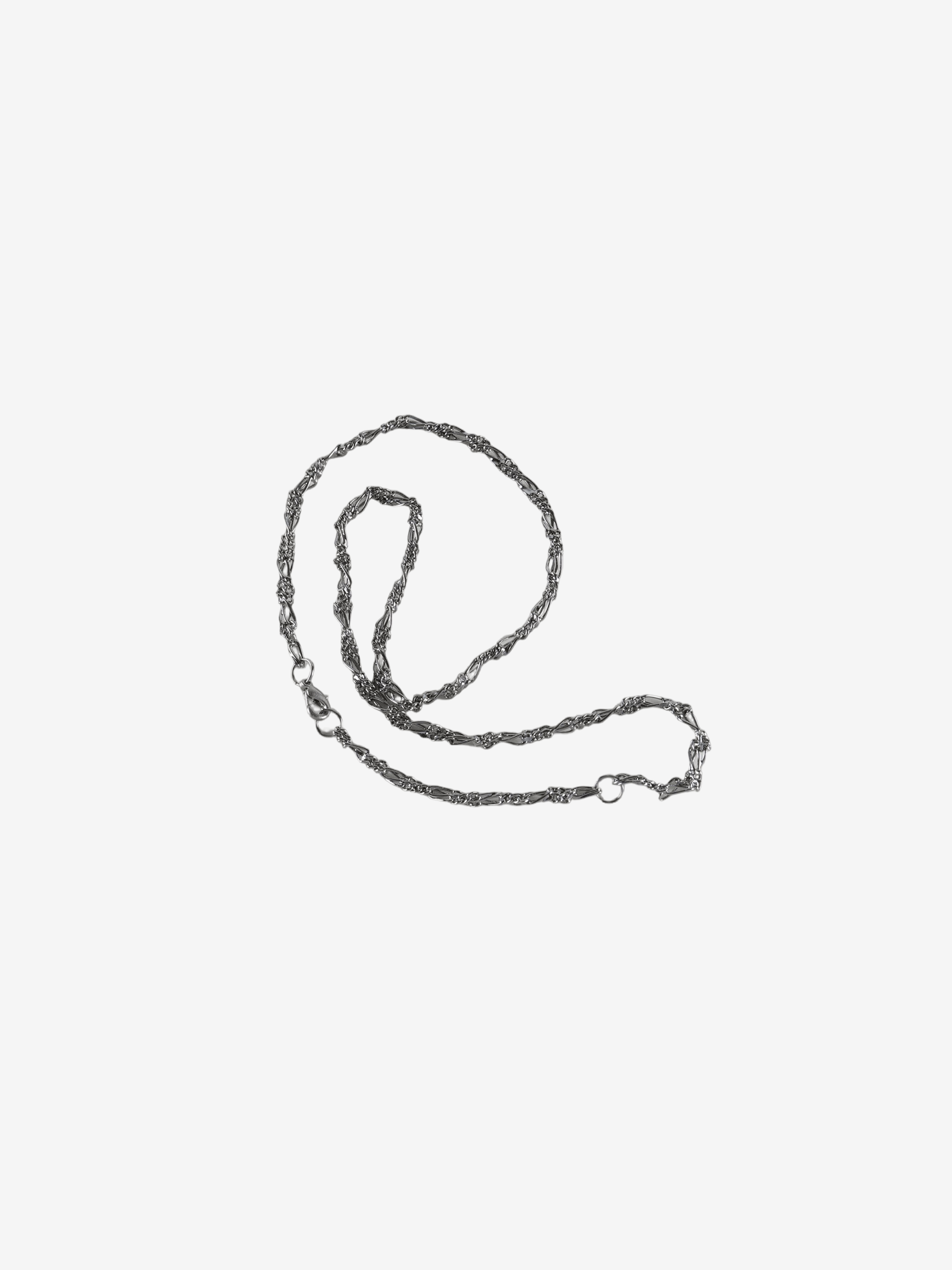 Close up of grey small accessories, showing texture of the brass fabric