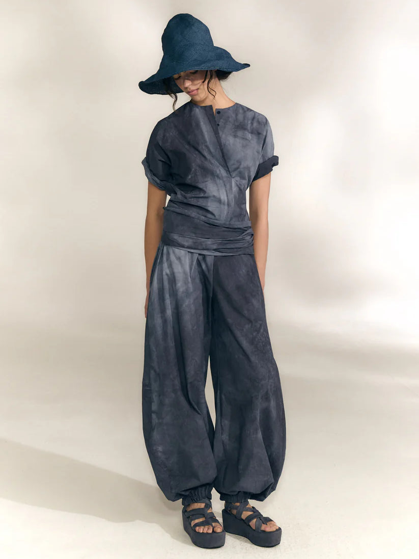 Navy pants worn by a person, showing the pants' fit