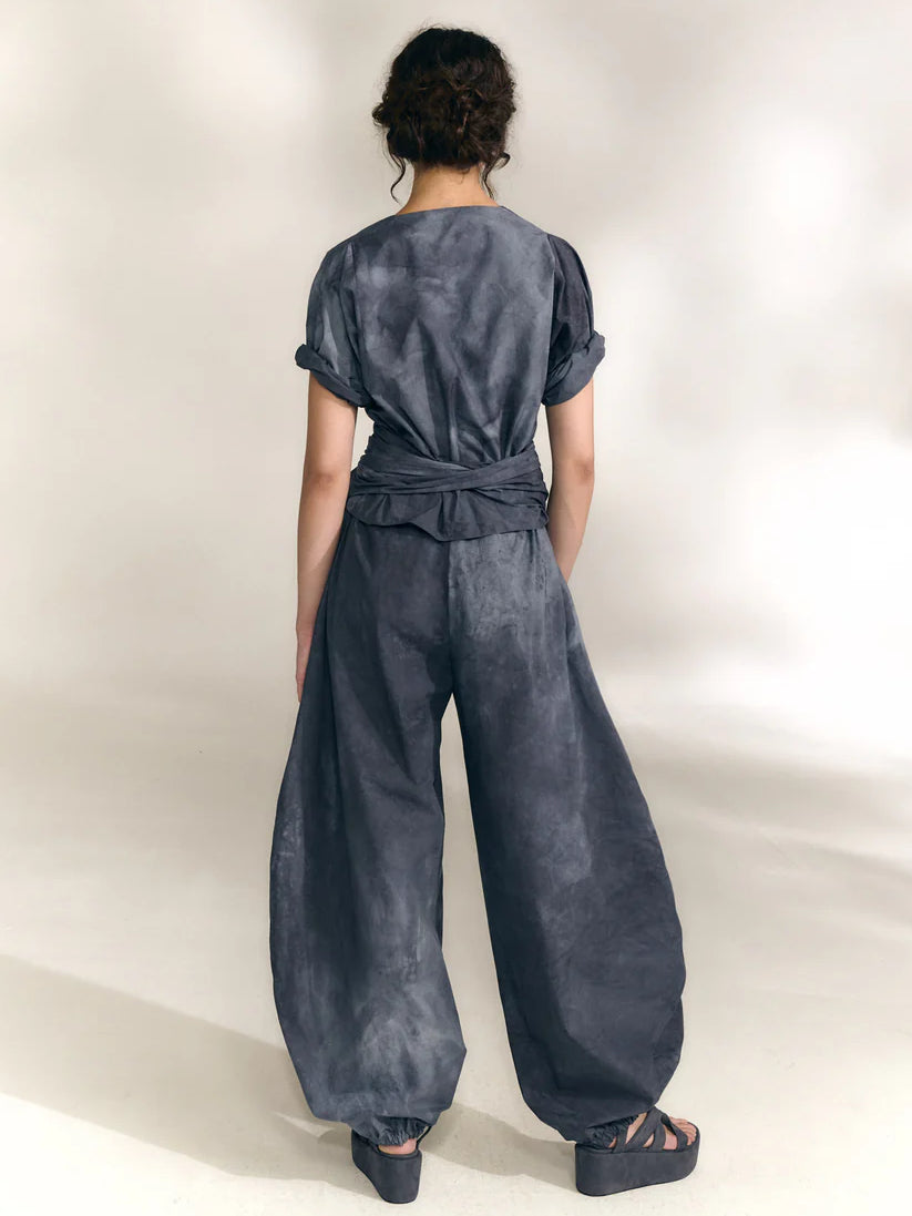 Navy pants worn by a person, showing the pants' fit