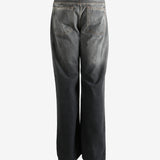 Black pant worn by a person, showing the pant's fit