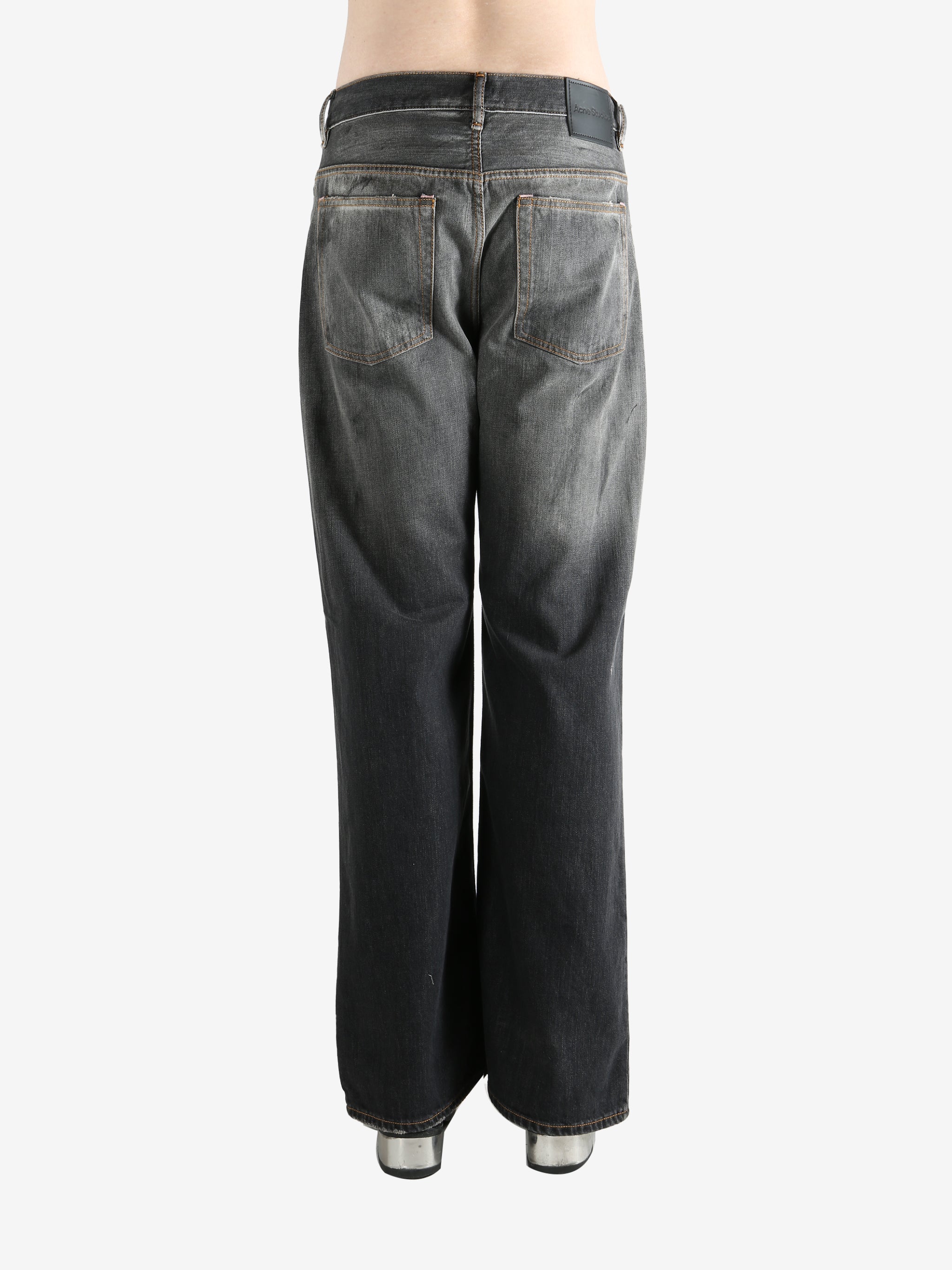 Black pant worn by a person, showing the pant's fit