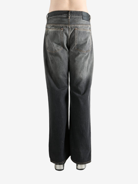 Black pant worn by a person, showing the pant's fit