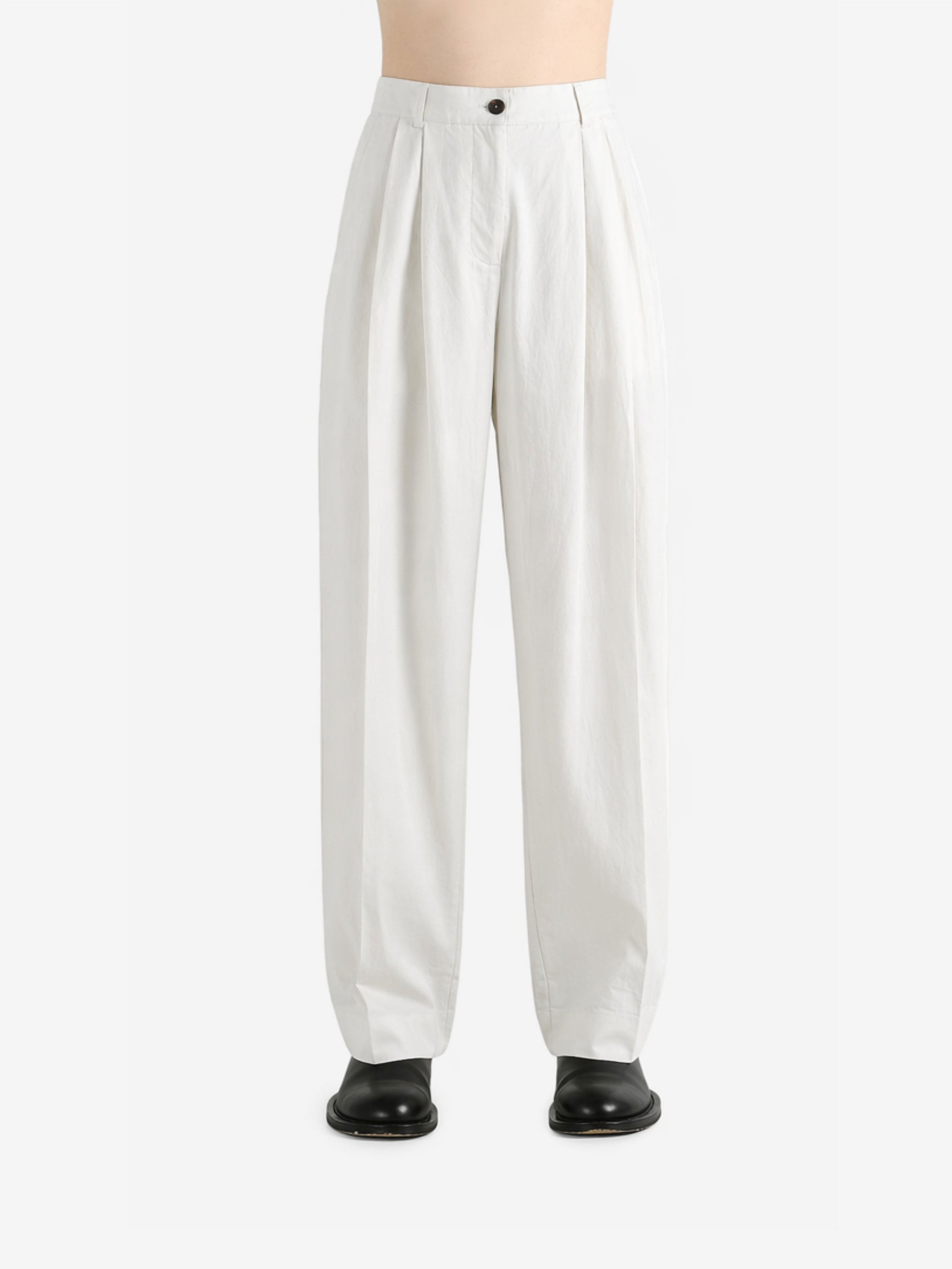 White pants worn by a person, showing the pants fit