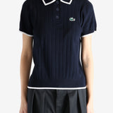 Navy knitwear worn by a person, showing the knitwear's fit