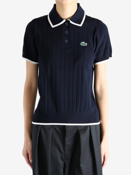 Navy knitwear worn by a person, showing the knitwear's fit