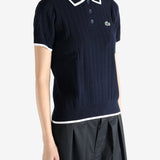 Navy knitwear worn by a person, showing the knitwear's fit