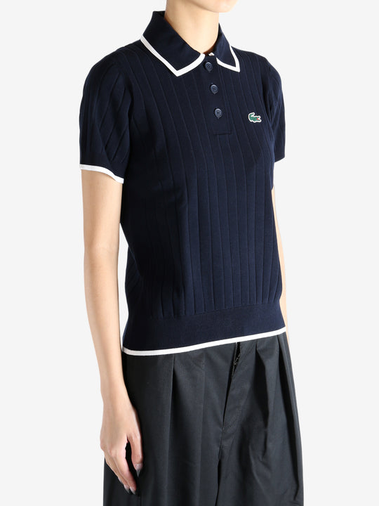 Navy knitwear worn by a person, showing the knitwear's fit