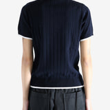 Navy knitwear worn by a person, showing the knitwear's fit