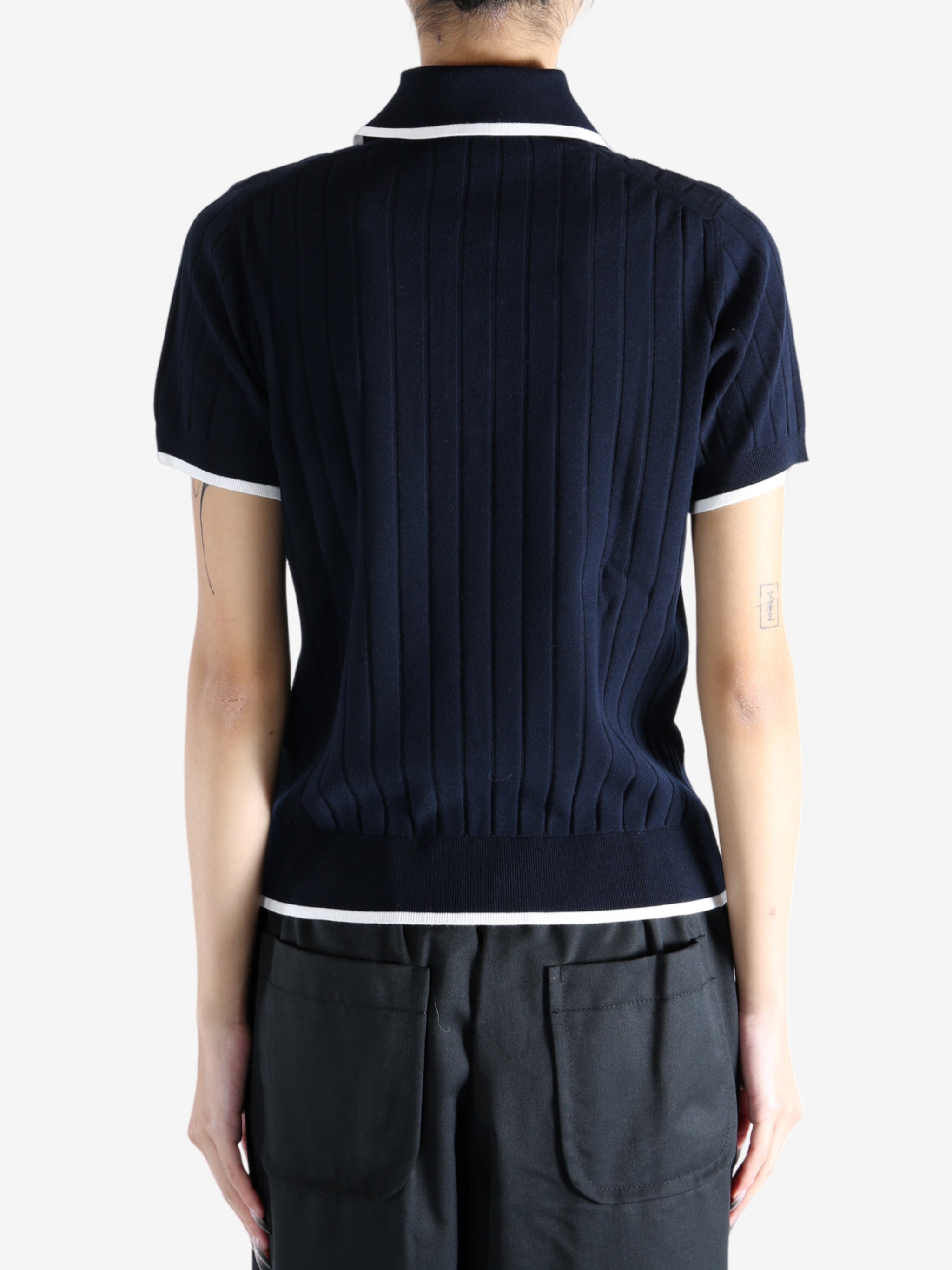Navy knitwear worn by a person, showing the knitwear's fit