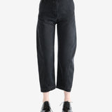 Black pants worn by a person, showing the pants's fit