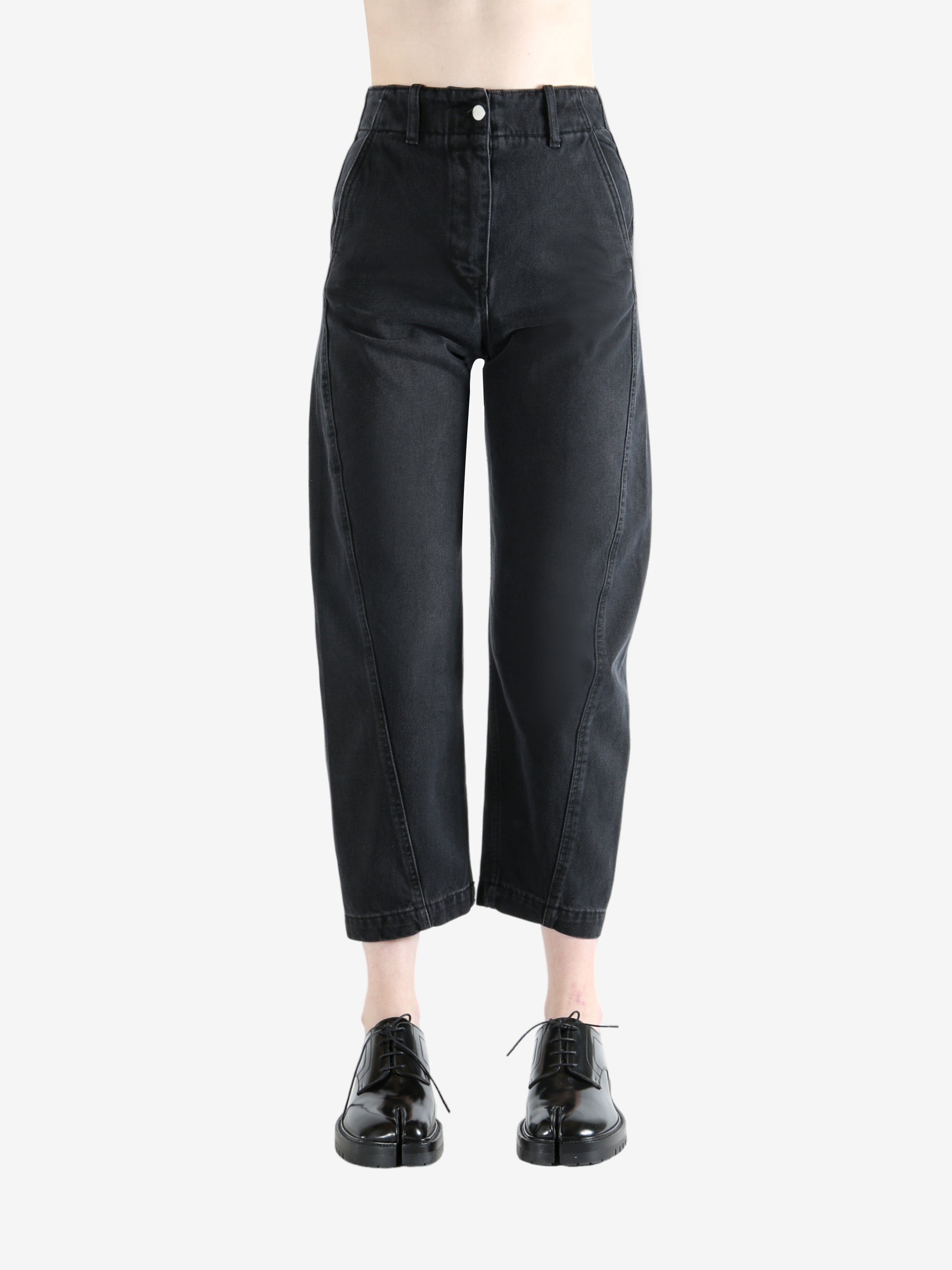 Black pants worn by a person, showing the pants's fit