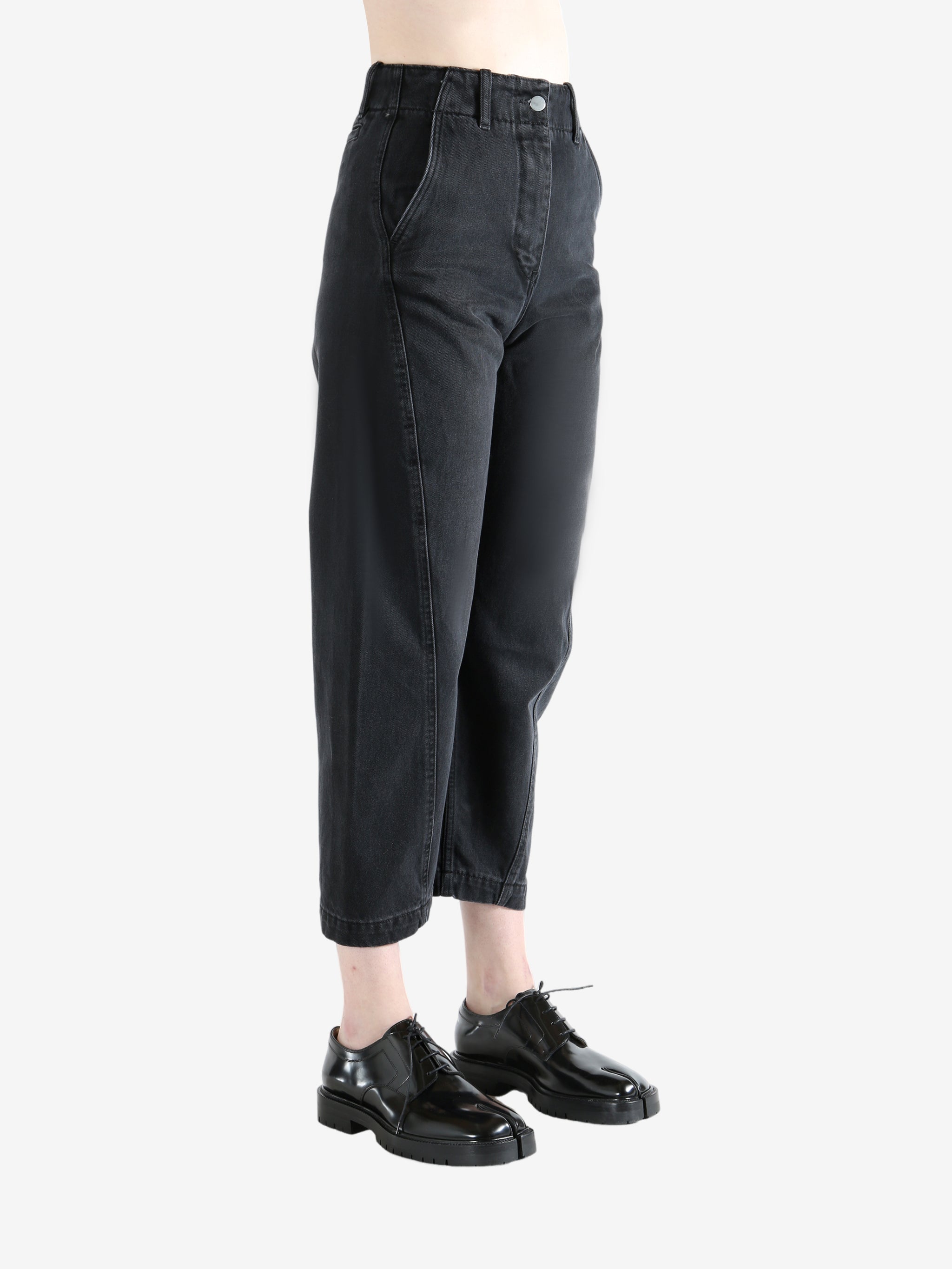 Black pants worn by a person, showing the pants's fit