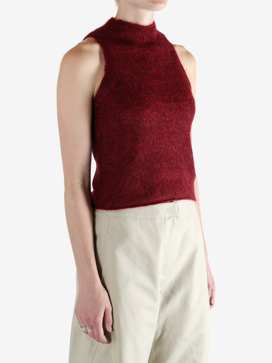 Red tops worn by a person, showing the top fit