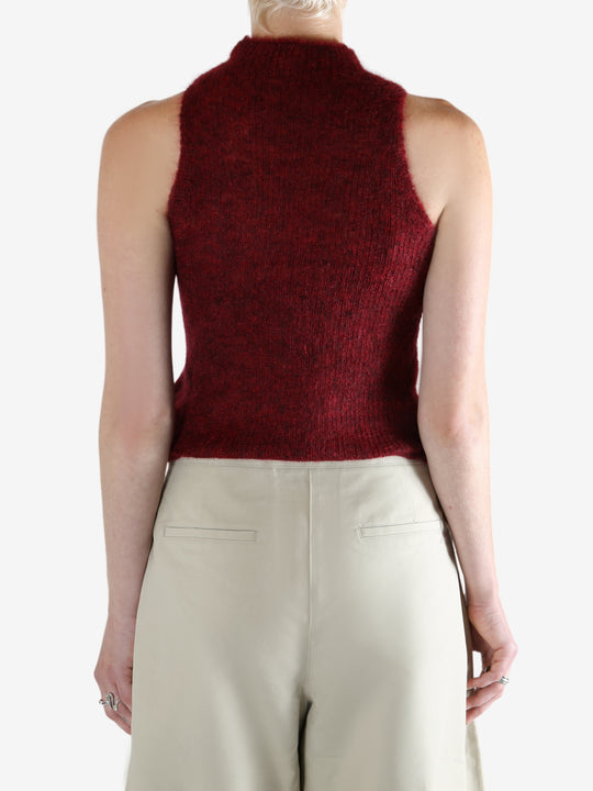 Red tops worn by a person, showing the top fit