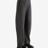 Grey pants  worn by a person, showing the pants fit