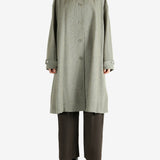 Grey coat worn by a person, showing the coat fit