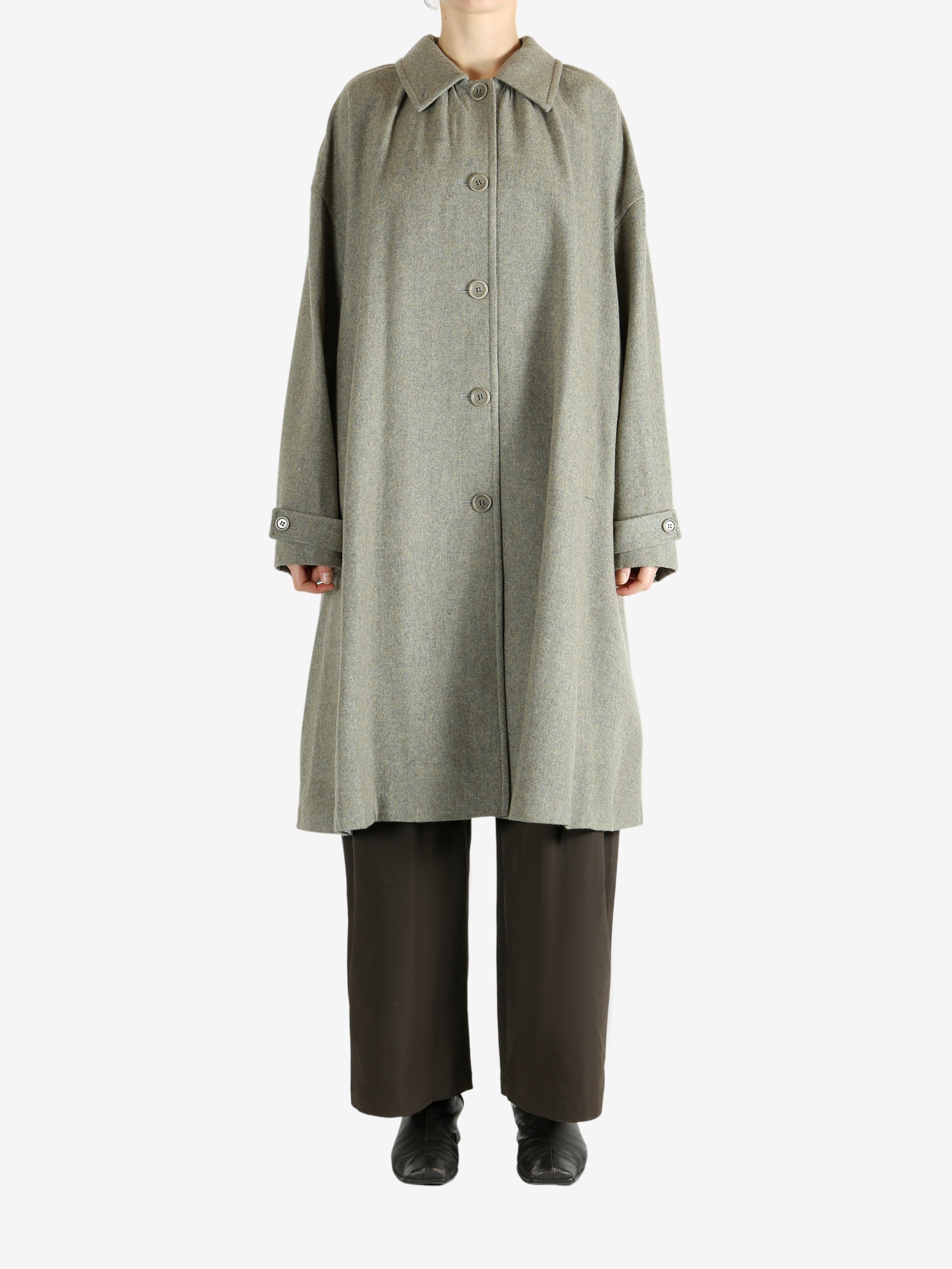 Grey coat worn by a person, showing the coat fit