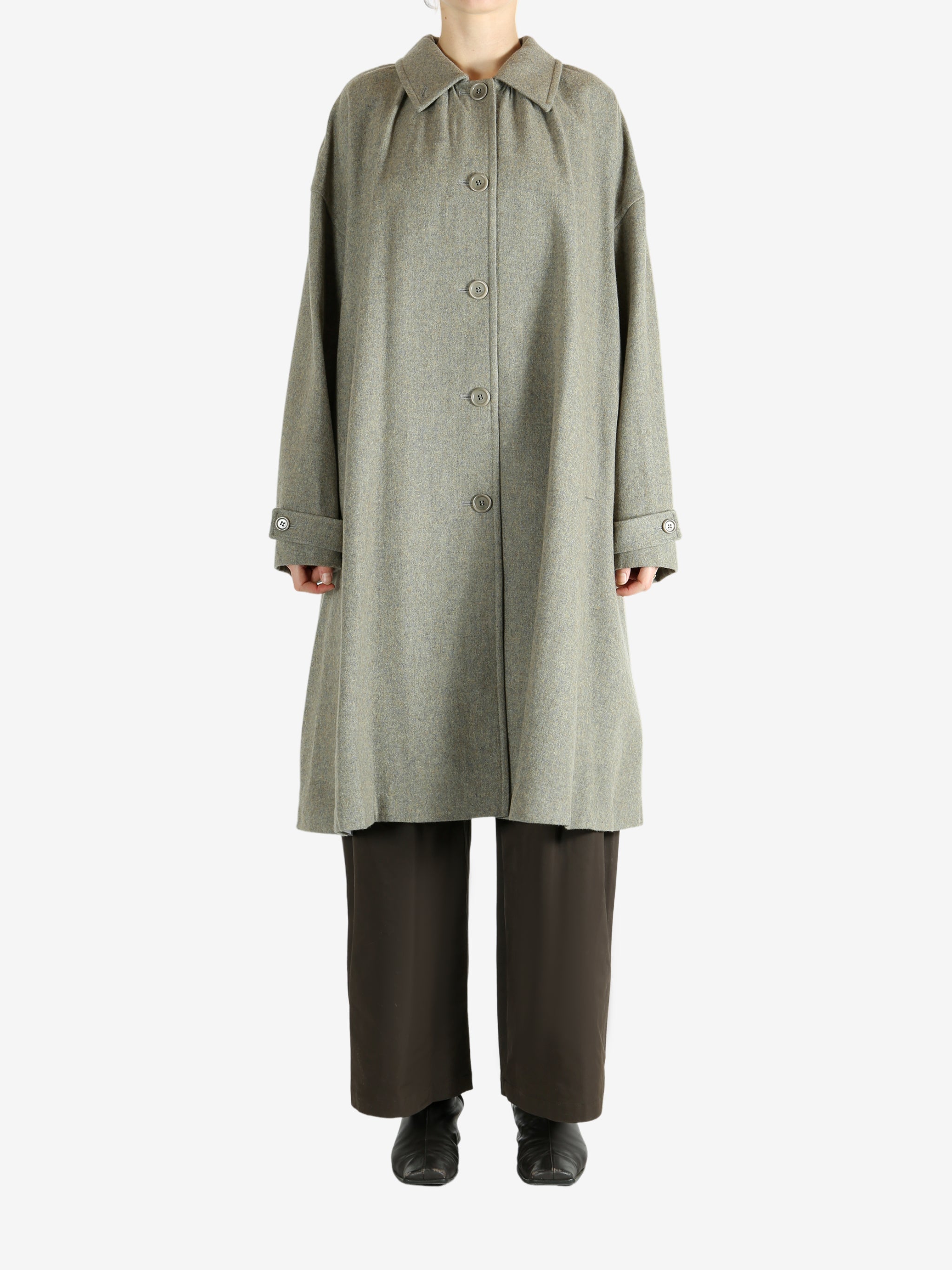 Grey coat worn by a person, showing the coat fit