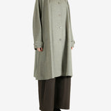 Grey coat worn by a person, showing the coat fit