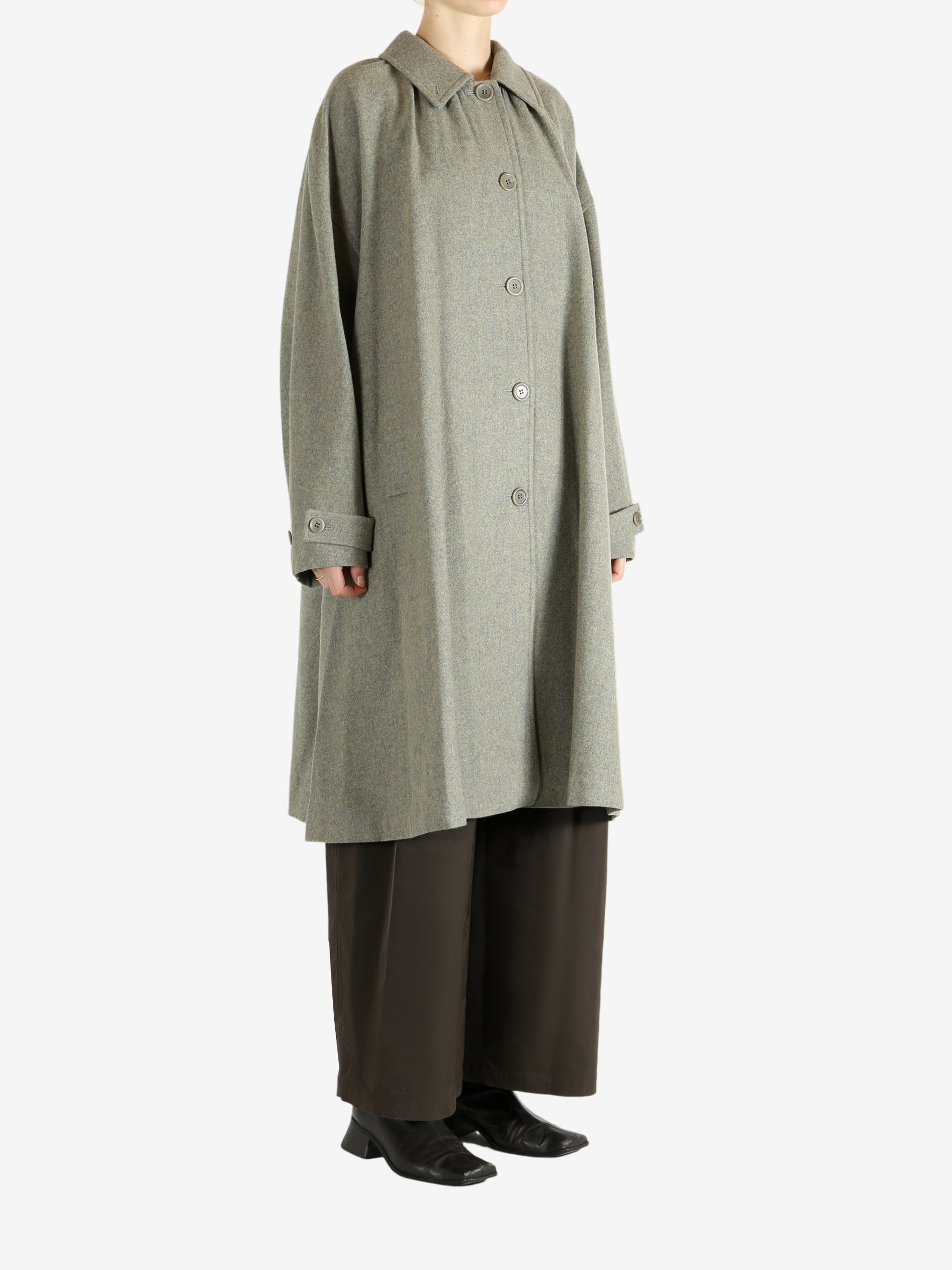 Grey coat worn by a person, showing the coat fit