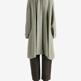 Grey coat worn by a person, showing the coat fit