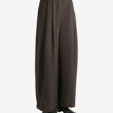 Green pants worn by a person, showing the pants fit