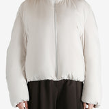 White jumper worn by a person, showing the jumper fit