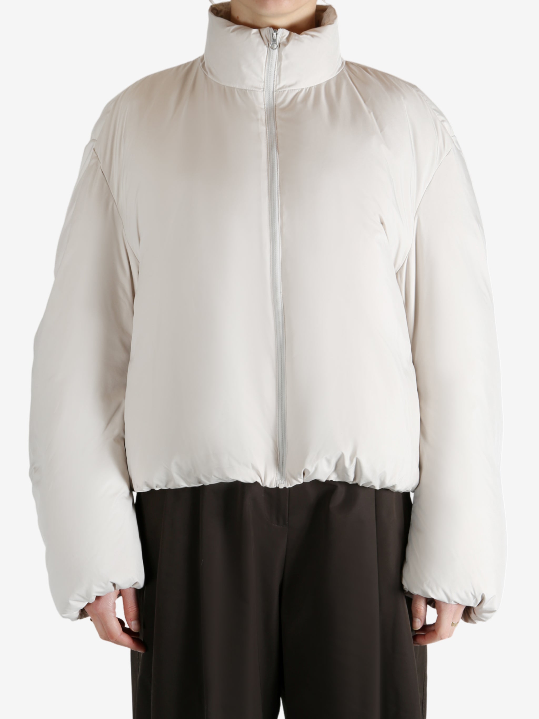 White jumper worn by a person, showing the jumper fit