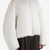 White jumper worn by a person, showing the jumper fit