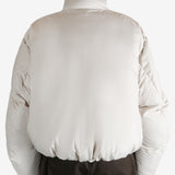 White jumper worn by a person, showing the jumper fit