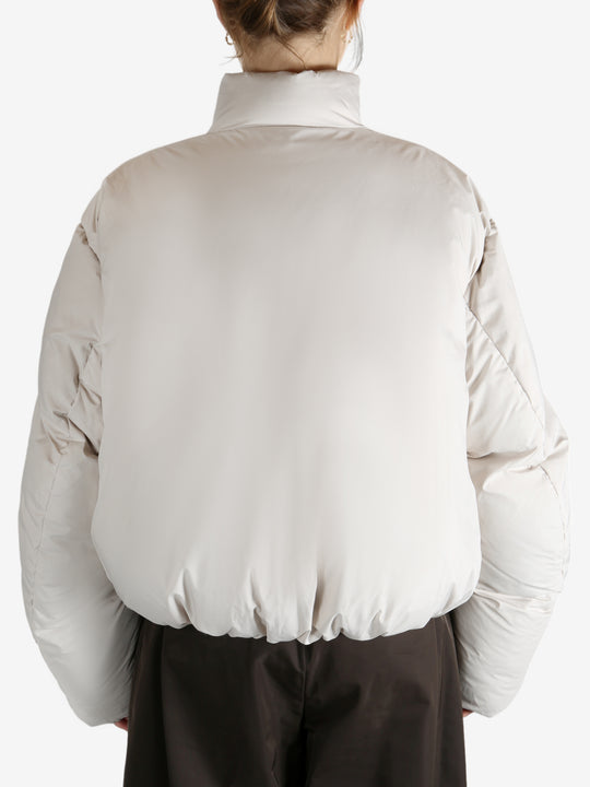 White jumper worn by a person, showing the jumper fit