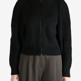 Black cardigan worn by a person, showing the cardigan fit