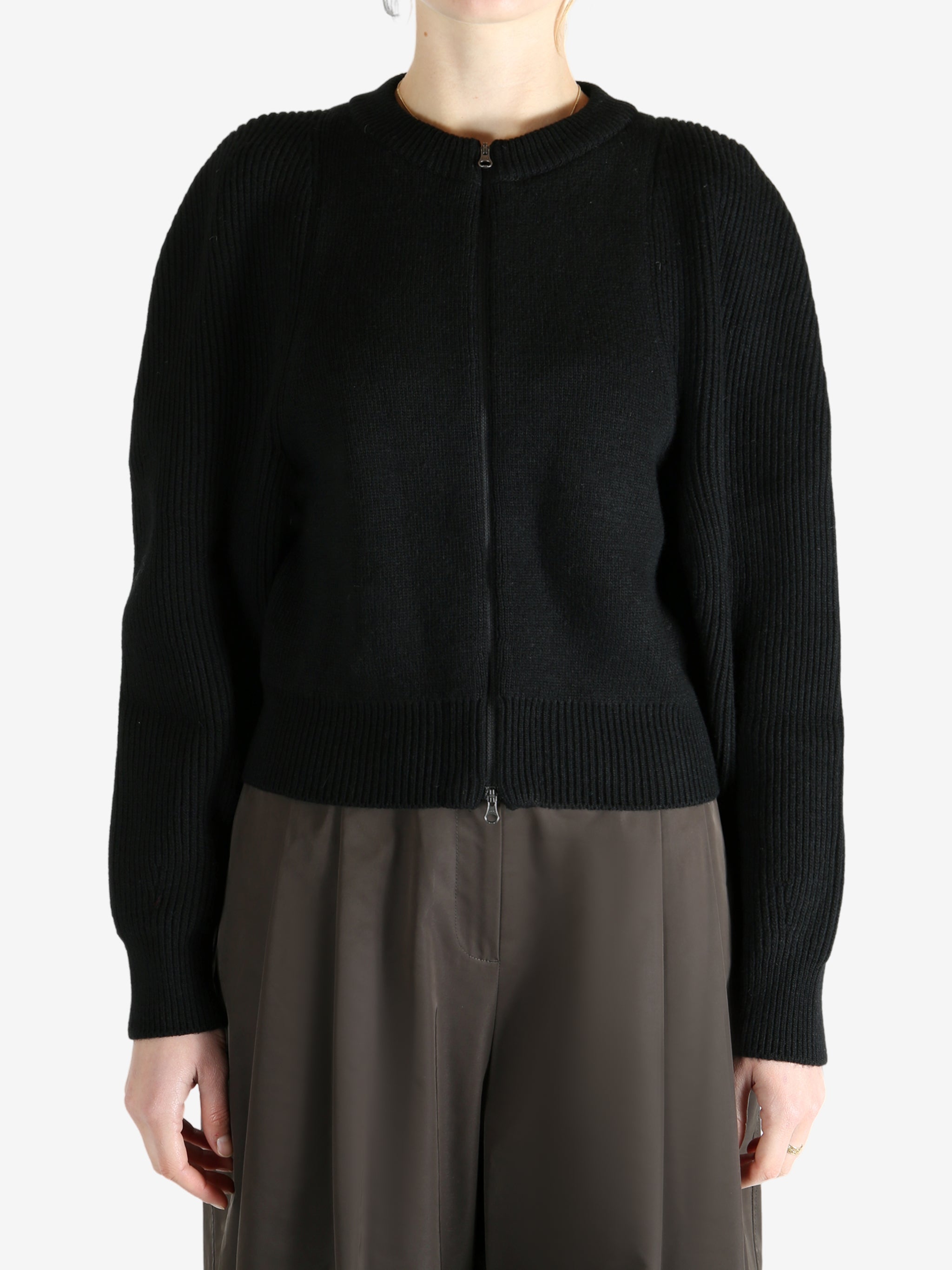 Black cardigan worn by a person, showing the cardigan fit