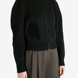 Black cardigan worn by a person, showing the cardigan fit
