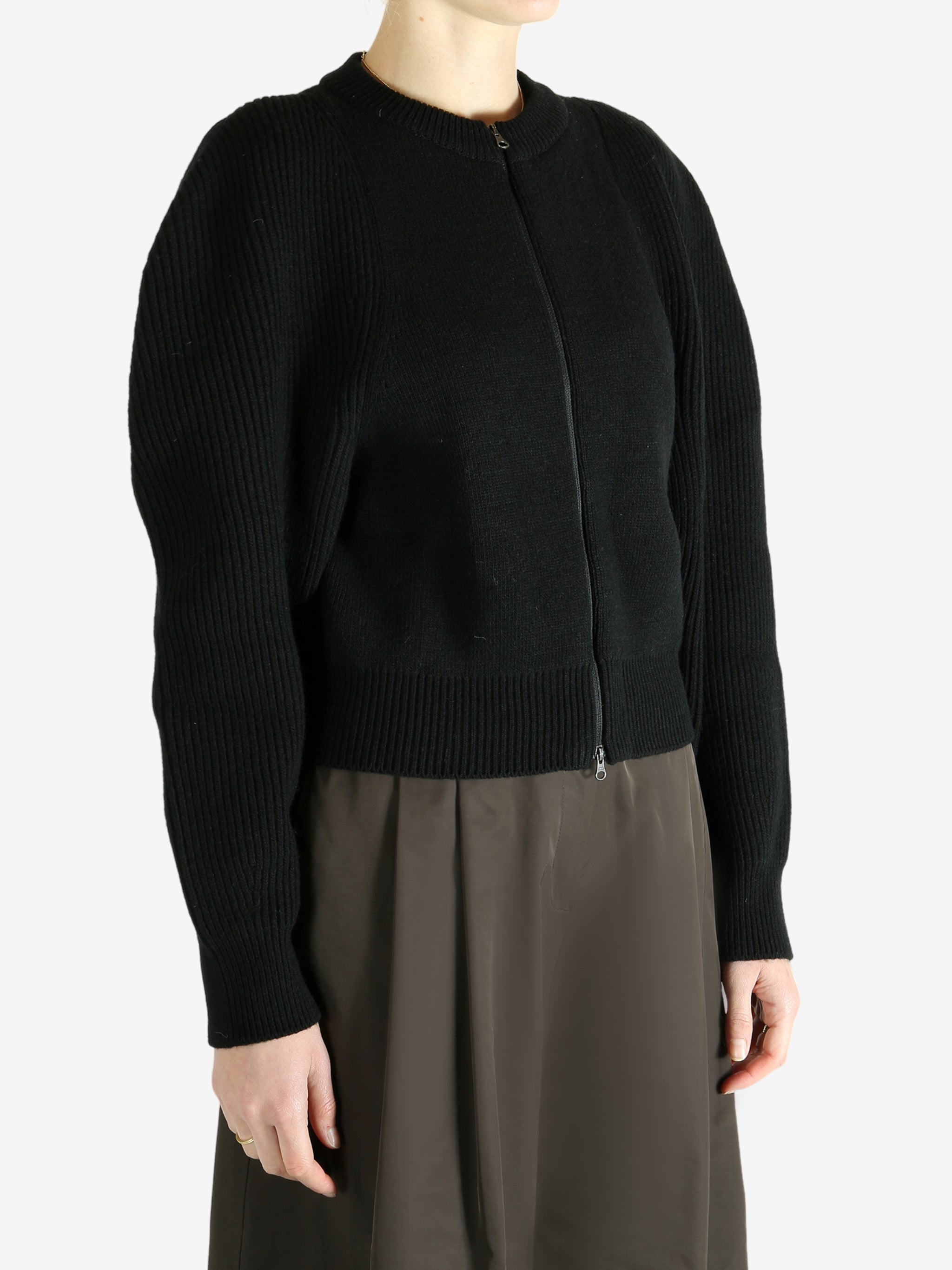 Black cardigan worn by a person, showing the cardigan fit