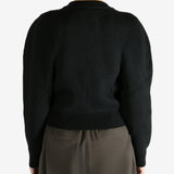 Black cardigan worn by a person, showing the cardigan fit