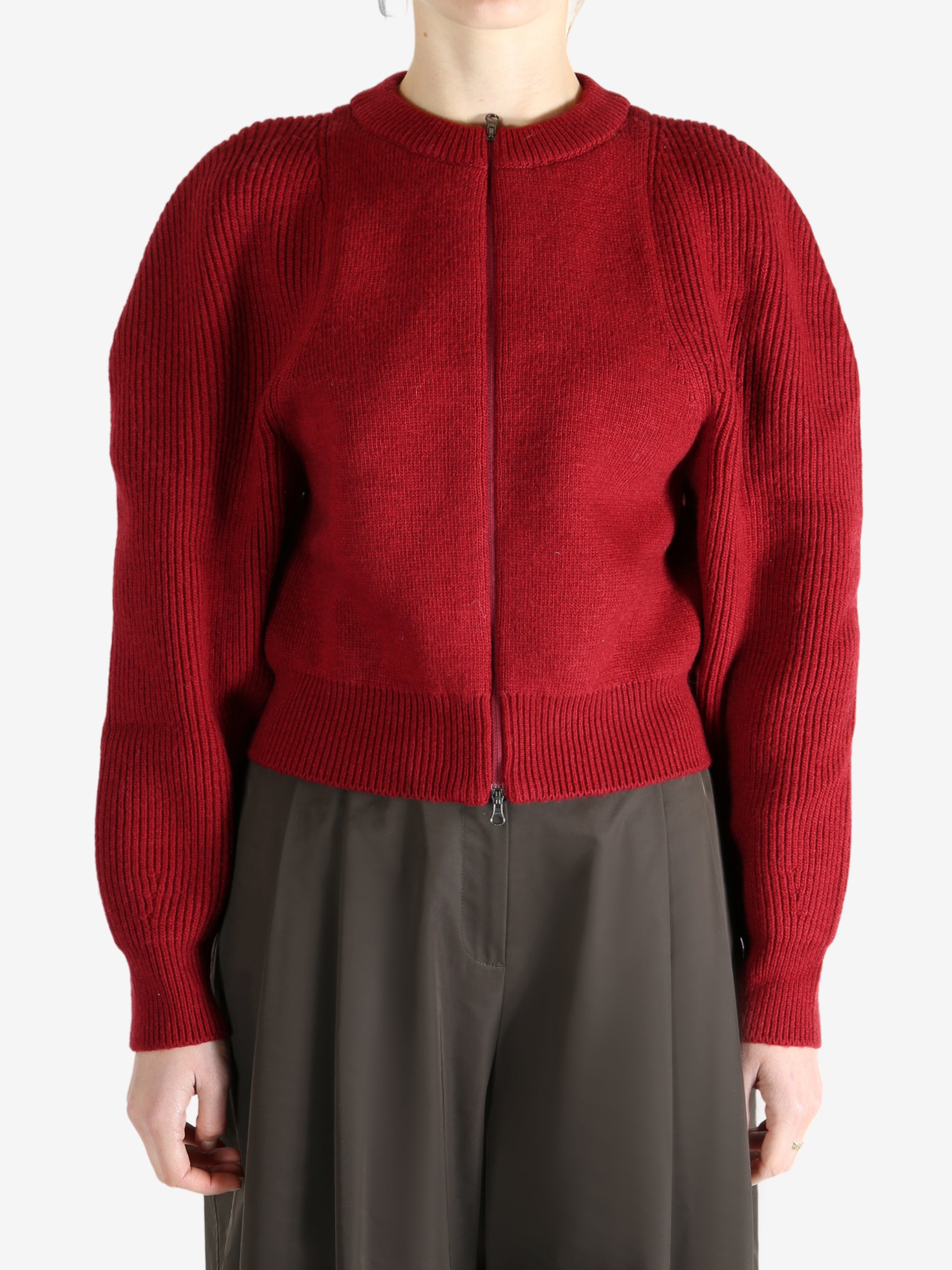 Red cardigan worn by a person, showing the cardigan fit