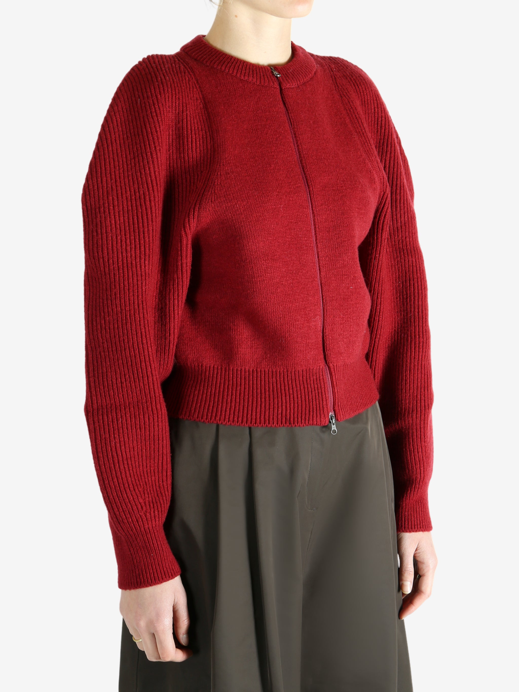 Red cardigan worn by a person, showing the cardigan fit