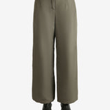 Tan pants worn by a person, showing the pants fit