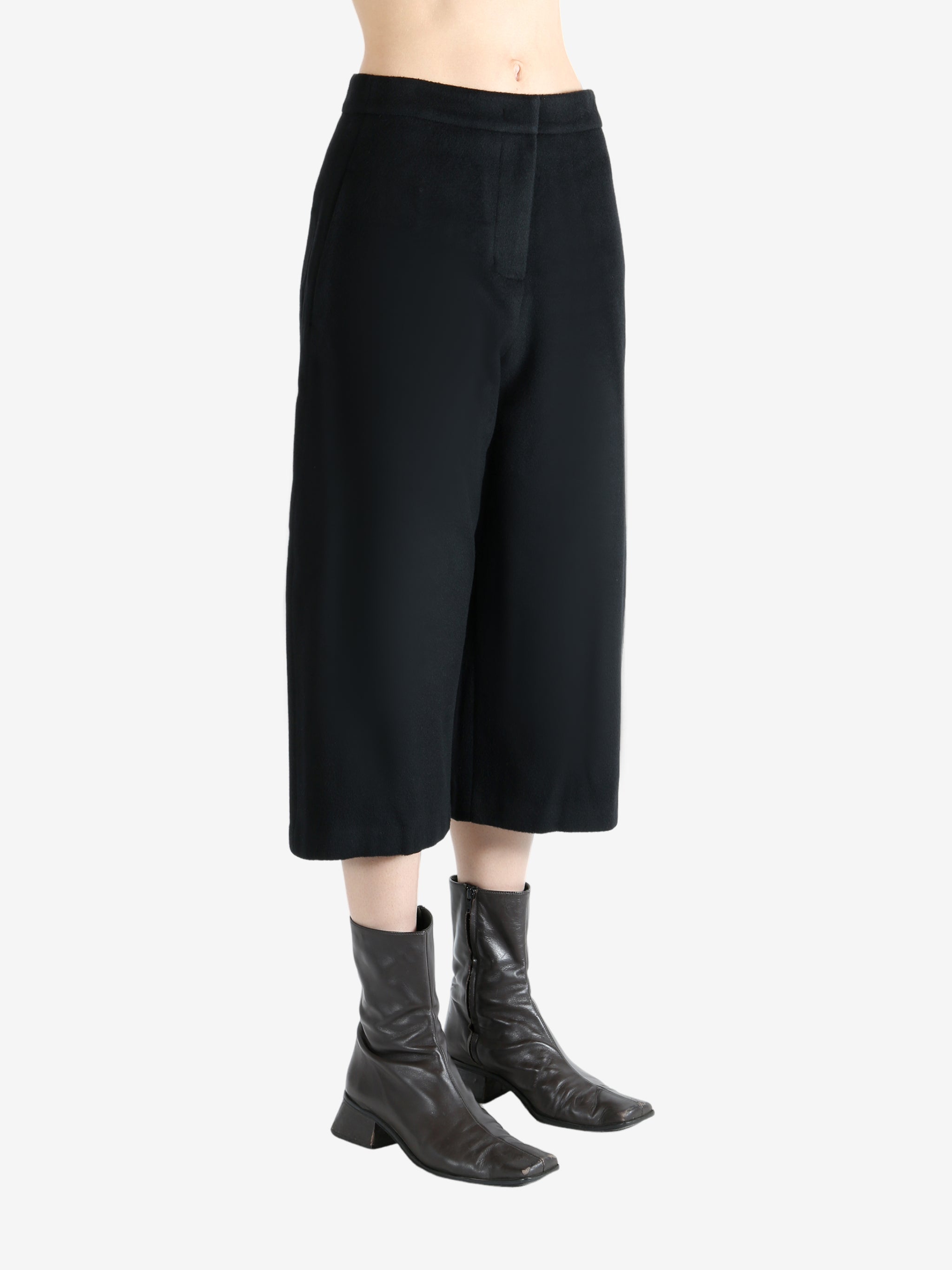 Black pants worn by a person, showing the pants fit