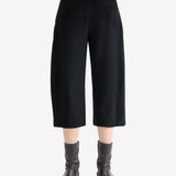 Black pants worn by a person, showing the pants fit