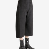 Brown pants worn by a person, showing the pants fit