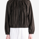 Brown jacket worn by a person, showing the jacket's fit
