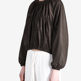 Brown jacket worn by a person, showing the jacket's fit