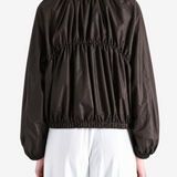 Brown jacket worn by a person, showing the jacket's fit