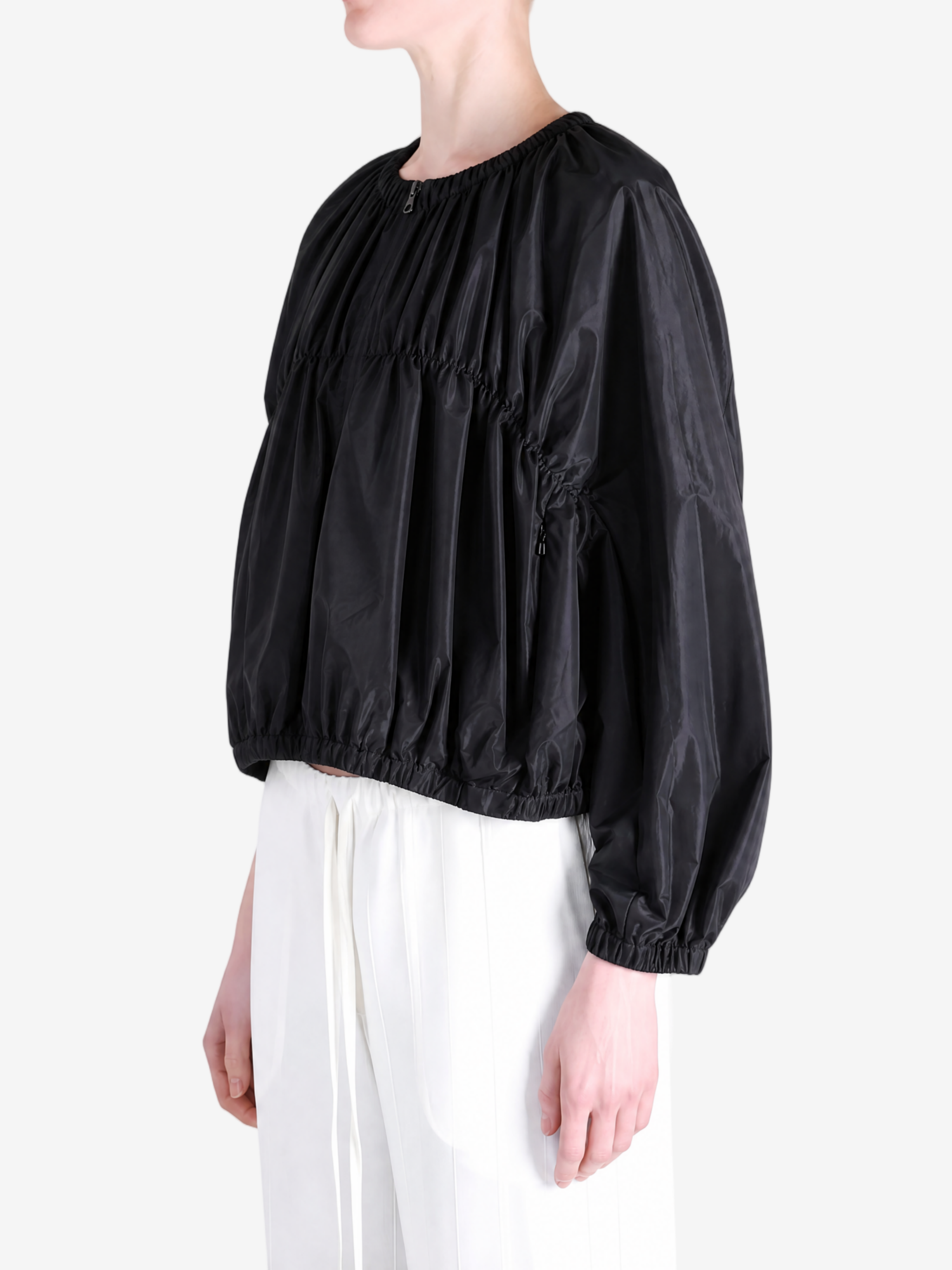Black jacket worn by a person, showing the jacket's fit