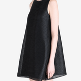 Black dress worn by a person, side view
