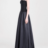 Black dress worn by a person, side view