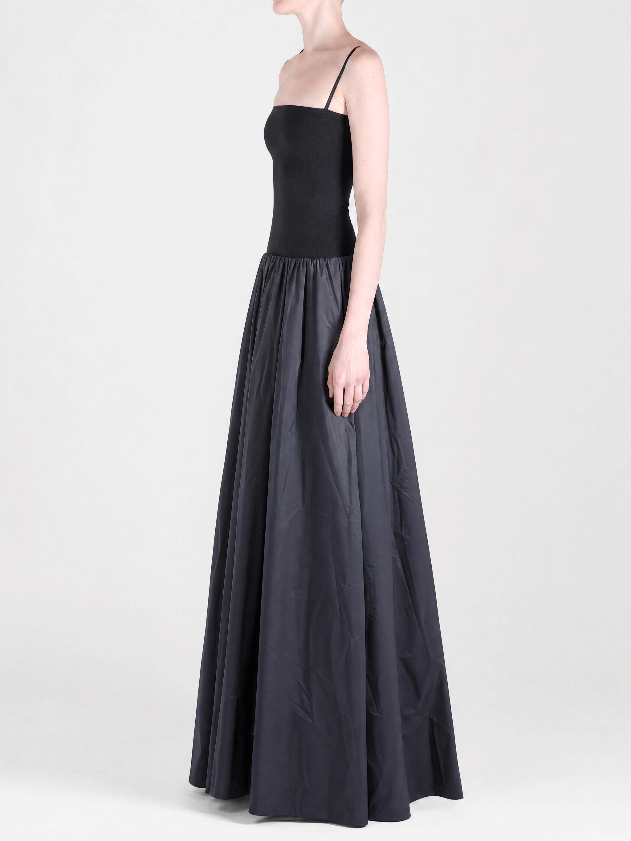 Black dress worn by a person, side view